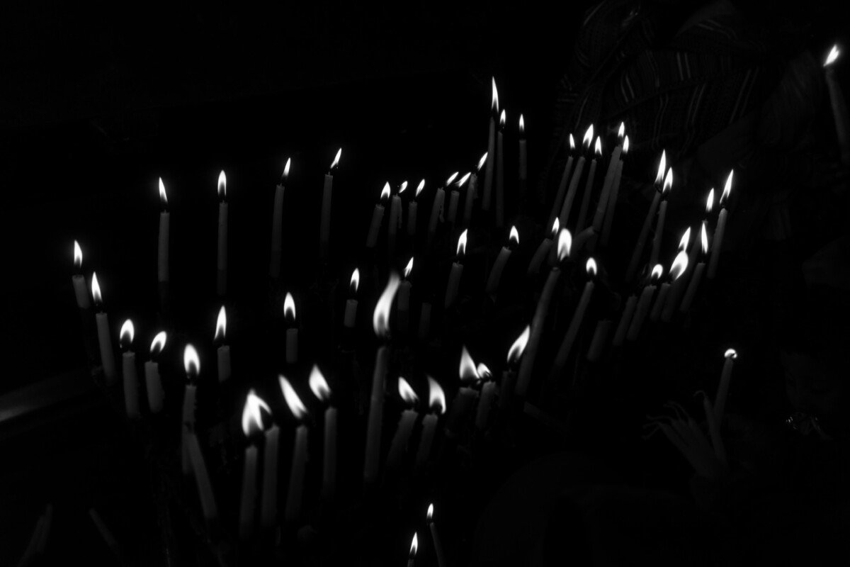 Elegant black and white image of lit candles creating a serene and moody atmosphere.