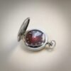 Orologio da tasca vintage russo, cassa argentata, quadrante rosso-marrone con numeri arabi, pattern floreale e piccoli secondi a ore 9.